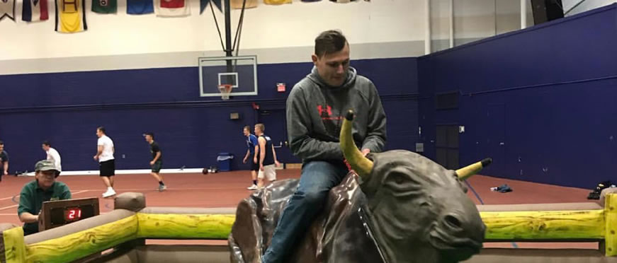 Student riding mechanical bull