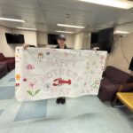 Students holding a Mother's Day banner