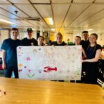 Students holding a Mother's Day banner