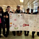 Students holding a Mother's Day banner