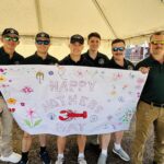 Students holding a Mother's Day banner
