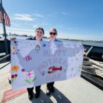 Students holding a Mother's Day banner