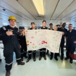Students holding a Mother's Day banner