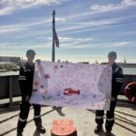 Students holding a Mother's Day banner