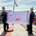 Students holding a Mother's Day banner