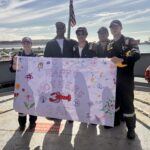 Students holding a Mother's Day banner