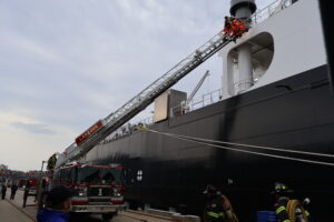 Firefighters getting on ship