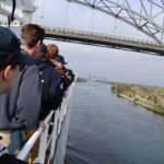 Ship traveling under bridge