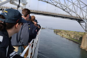 Ship traveling under bridge