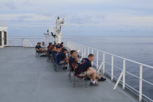 Engine Cadets relaxing topside, looking for wildlife.