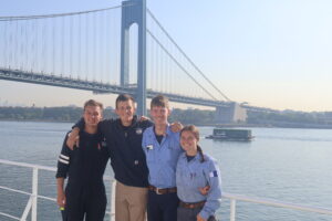 Cadets pose with bridge in background