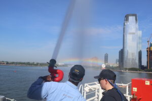 Cadet and crew spraying hose