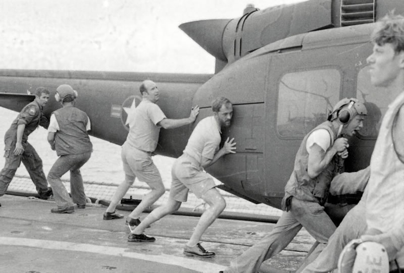 Paul Jacobs helping to push helicopter over edge of ship